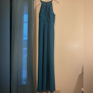 A long dark greenish color dress.